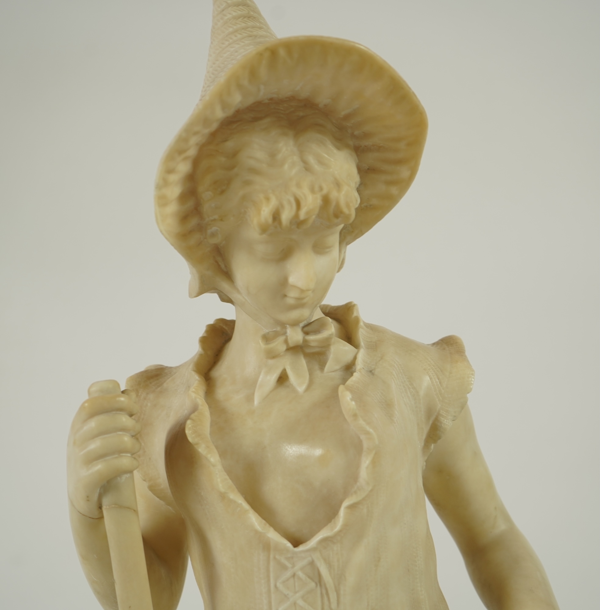 A Continental alabaster figure of a woman fishing, early 20th century